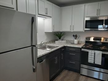 Modern kitchen with stainless steel appliances and double door refrigerators